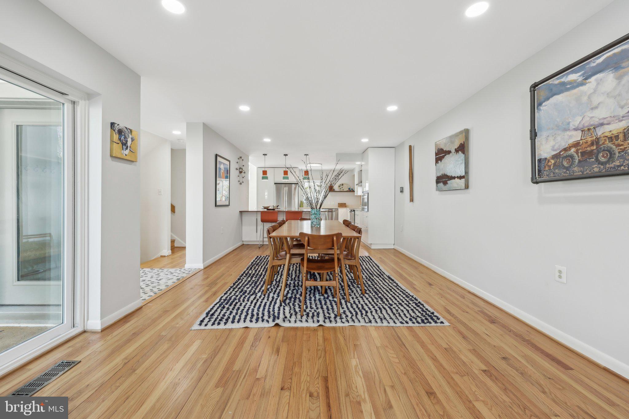 1503 Inlet Court Reston, VA 20190 - Photo 12 of 59 a dining room with wooden floor and large window