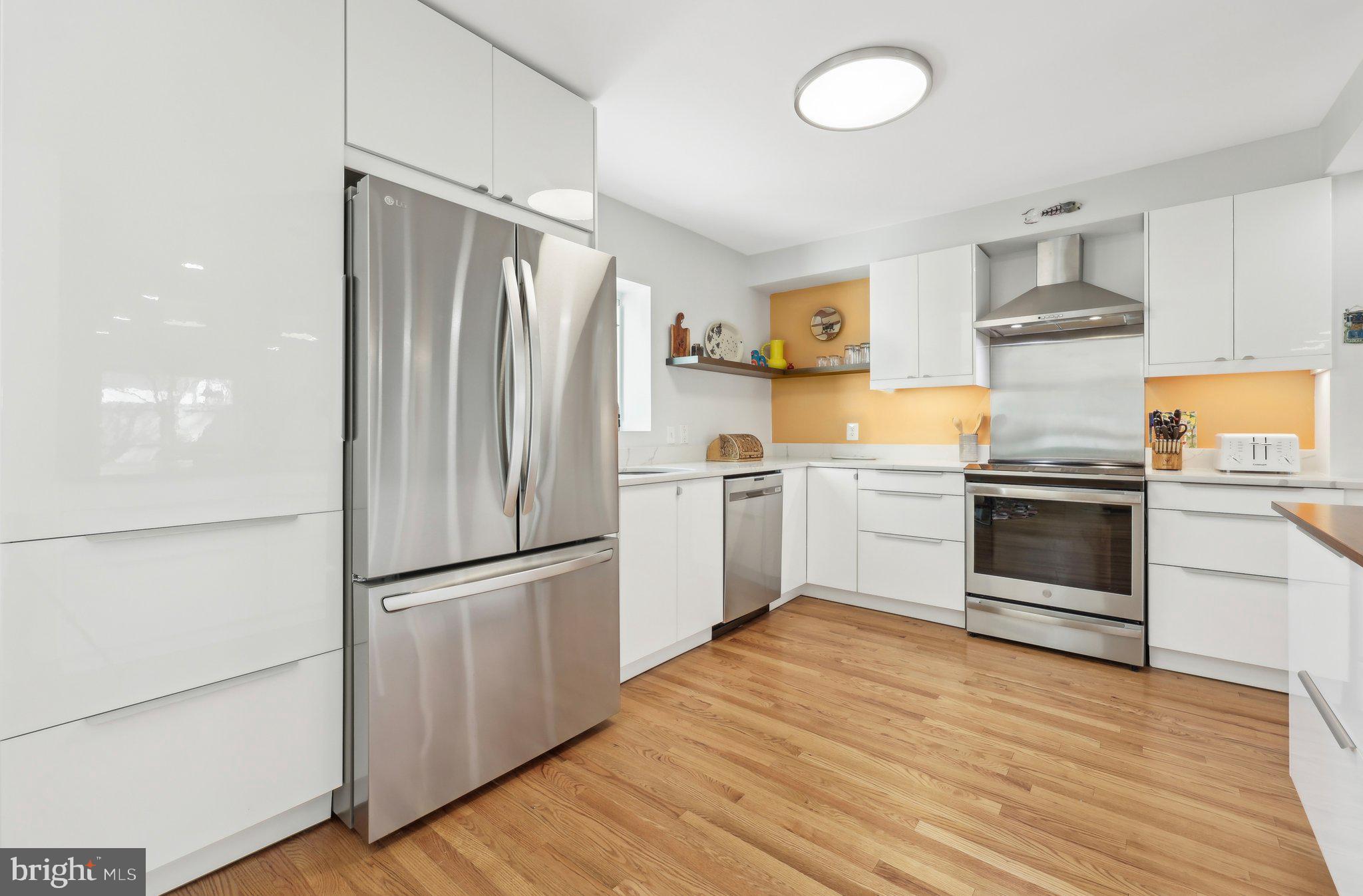 1503 Inlet Court Reston, VA 20190 - Photo 19 of 59 a kitchen with granite countertop a refrigerator stove and wooden floor