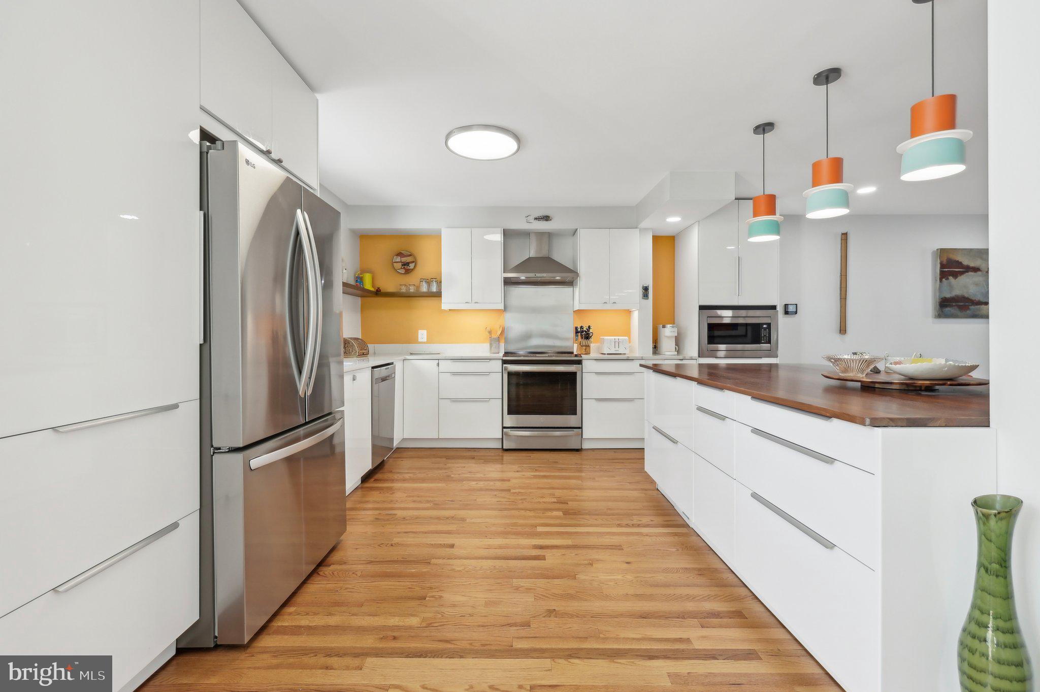 1503 Inlet Court Reston, VA 20190 - Photo 21 of 59 a large kitchen with cabinets and stainless steel appliances