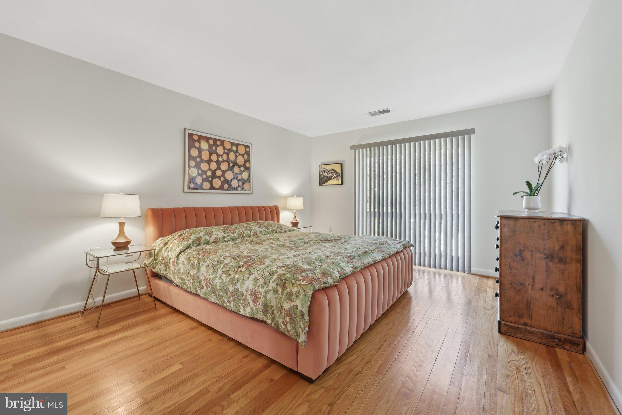 1503 Inlet Court Reston, VA 20190 - Photo 22 of 59 a bedroom with a bed and wooden floor