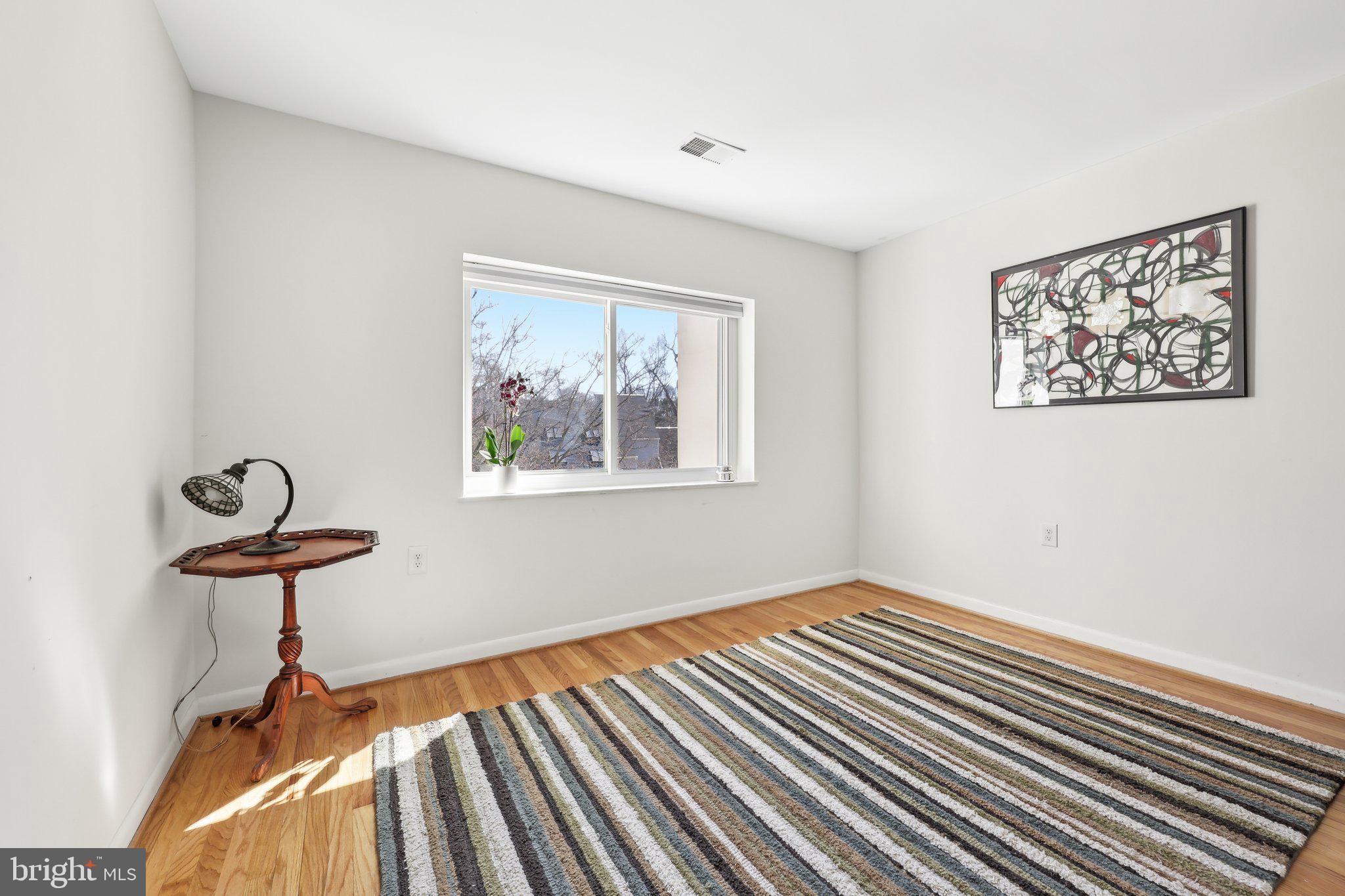 1503 Inlet Court Reston, VA 20190 - Photo 30 of 59 a view of a room with wooden floor wall painting and a window