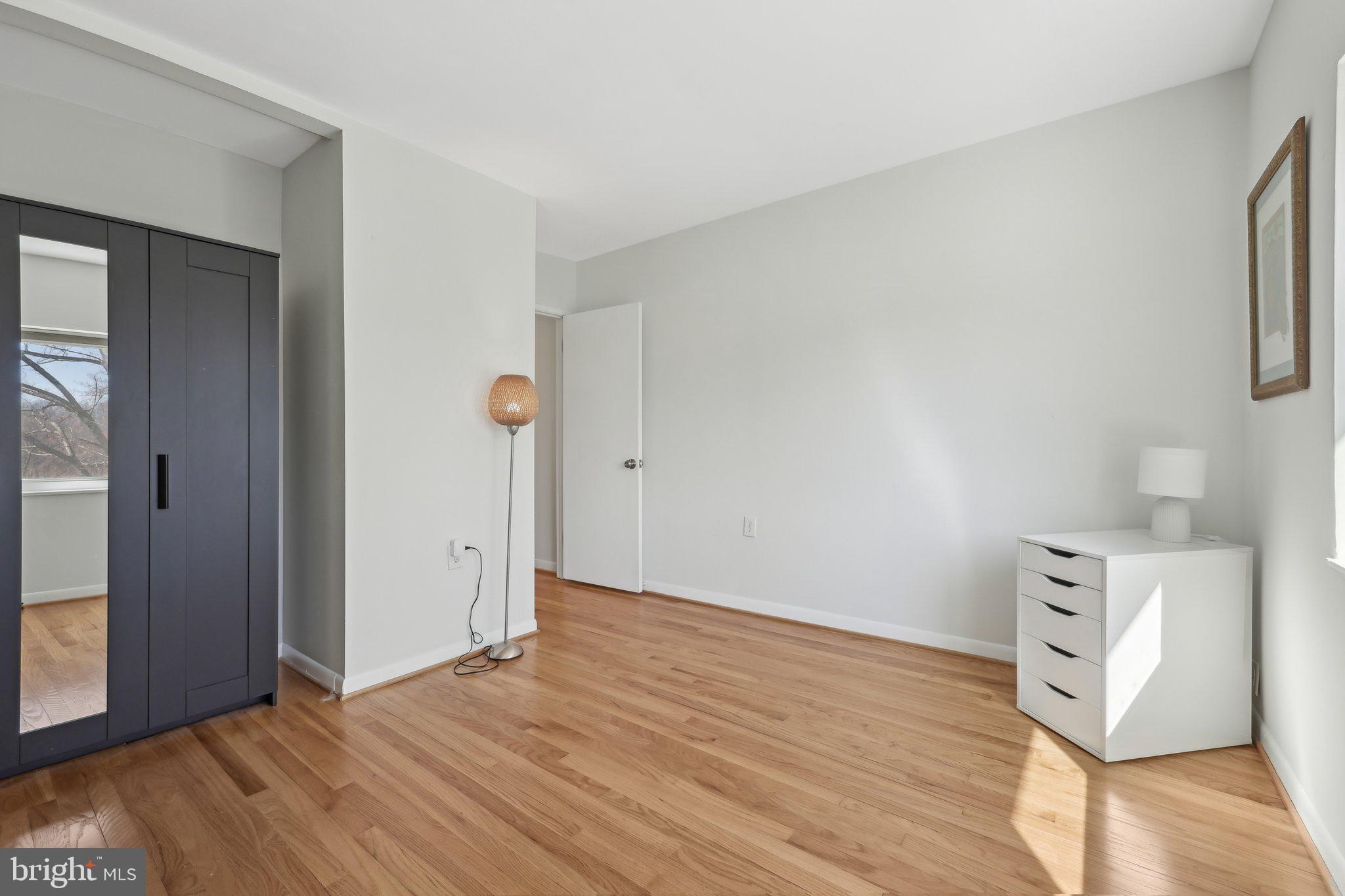 1503 Inlet Court Reston, VA 20190 - Photo 40 of 59 a view of an empty room with wooden floor and a window