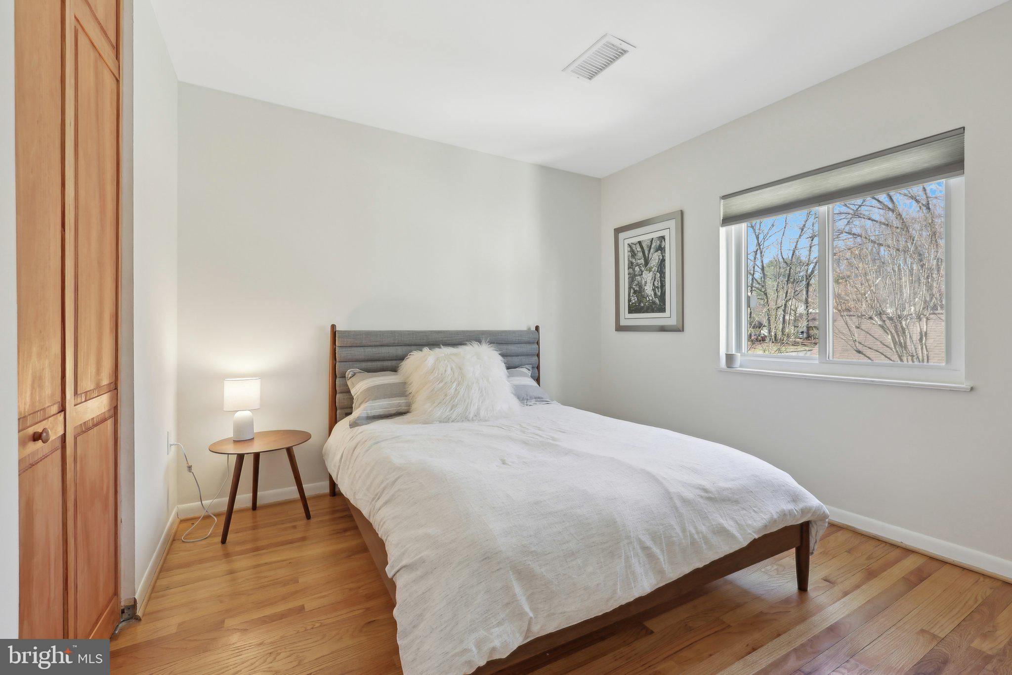 1503 Inlet Court Reston, VA 20190 - Photo 43 of 59 a bedroom with a bed and a painting on the wall
