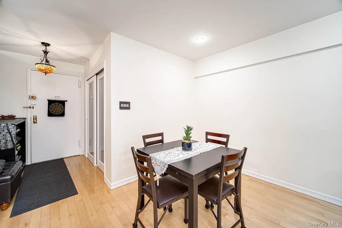 99-05 59th Avenue, Unit 2A Queens, NY 11368 - Photo 3 of 14 a view of a dining room with furniture and a chandelier