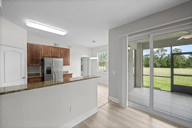 a kitchen with granite countertop wooden cabinets and stainless steel appliances