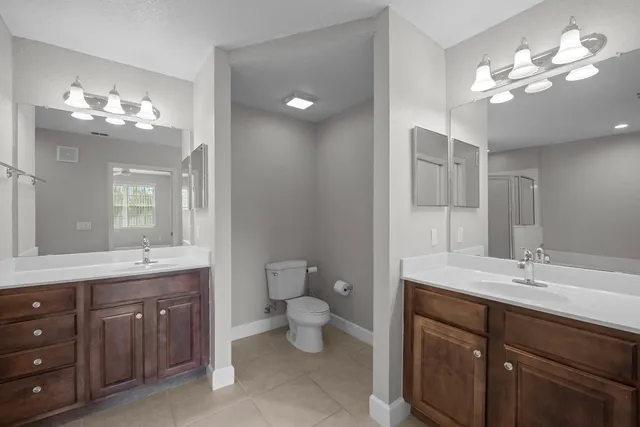 a spacious bathroom with a bathtub sink and mirror
