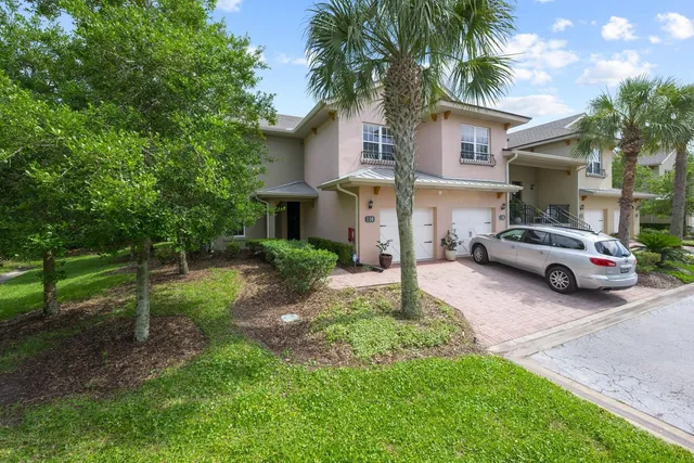 an aerial view of a house with swimming pool and green space