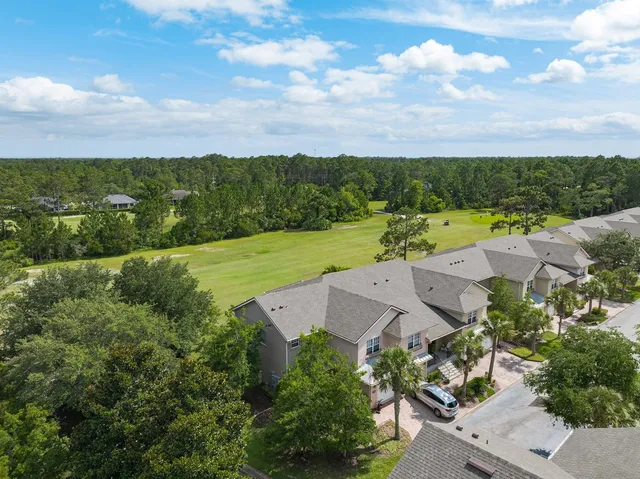 an aerial view of a houses with a lake view