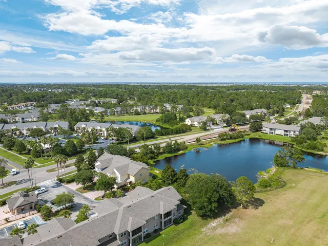 an aerial view of a house with a yard basket ball court and outdoor seating