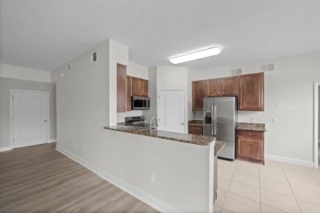a view of a kitchen with large windows