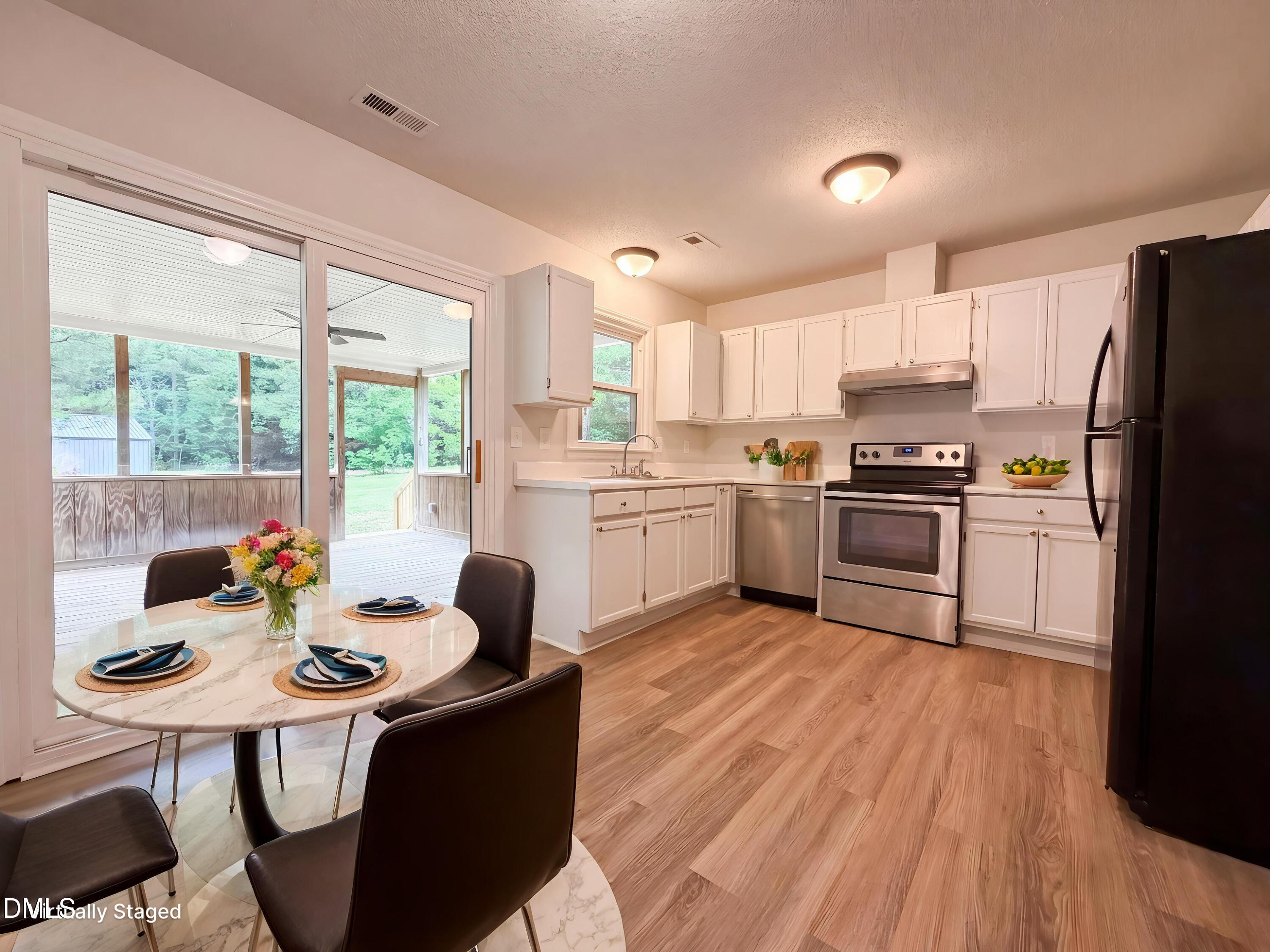 4894 Elevation Road, Unit C Benson, NC 27504 - Photo 7 of 24 a kitchen with granite countertop a sink appliances a counter space and a dining table