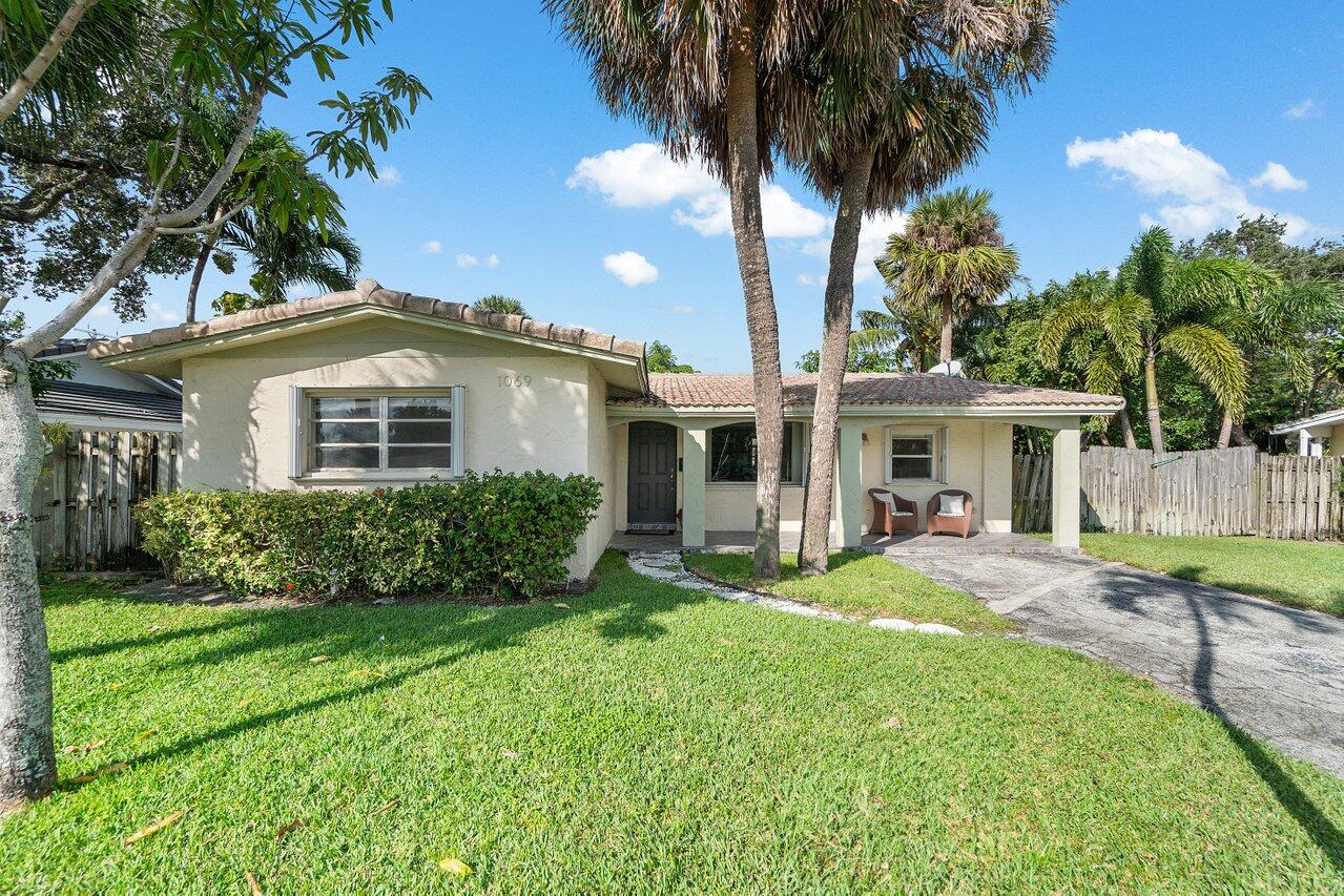 1069 West Camino Real Boca Raton, FL 33486 - Photo 2 of 21 a view of a house with a yard and sitting area