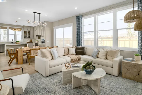 a living room with furniture a chandelier and a large window