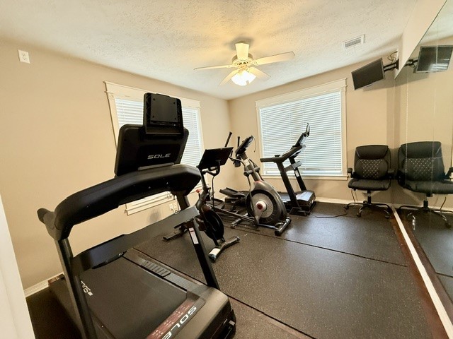 1000 Spring Loop, Unit 1806 College Station, TX 77840 - Photo 31 of 33 a room with gym equipment and a flat screen tv