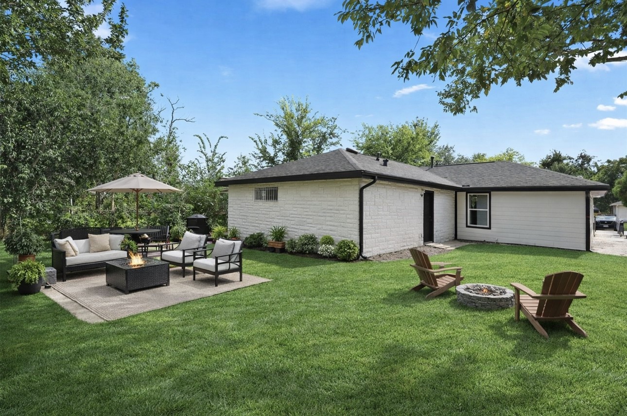 3013 Bloomfield Street Houston, TX 77051 - Photo 10 of 10 a view of a backyard with table and chairs under an umbrella