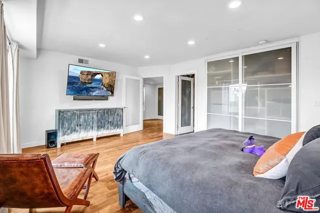 a bedroom with a bed and a flat screen tv