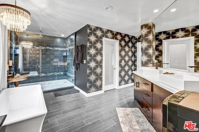 a bathroom with double vanity and a shower