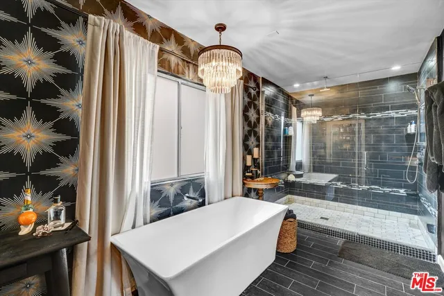 a very nice looking room with a large window and a chandelier