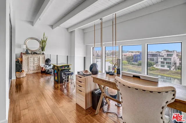 a very nice looking living room with a large window and dining table