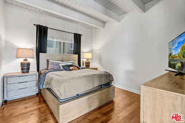 a bedroom with a bed and a flat screen tv