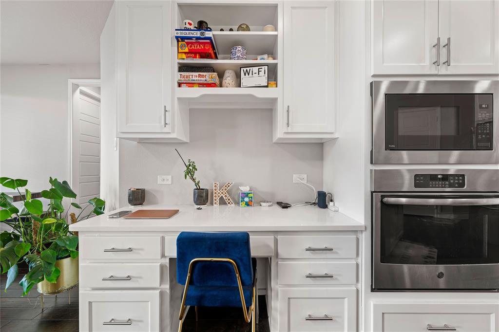 16541 Sweetgum Road Frisco, TX 75033 - Photo 11 of 28 Kitchen featuring white cabinetry, stainless steel appliances, light stone countertops, and an office area