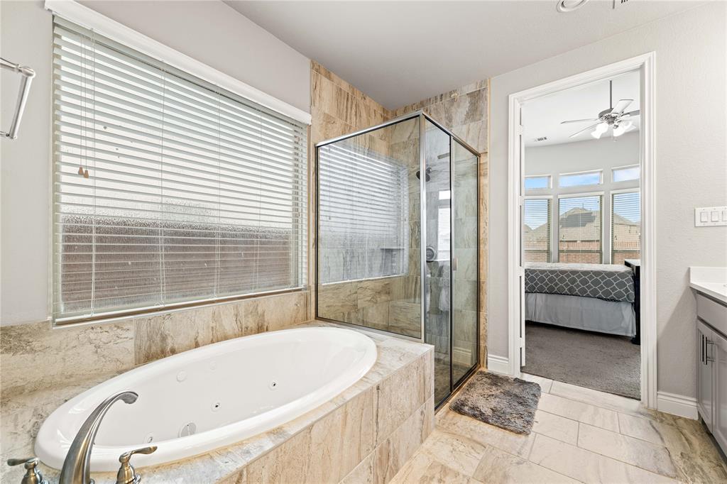 16541 Sweetgum Road Frisco, TX 75033 - Photo 18 of 28 Ensuite bathroom featuring a shower stall, vanity, a jetted tub, and a ceiling fan