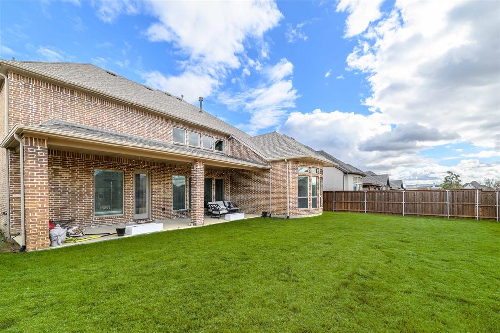 16541 Sweetgum Road Frisco, TX 75033 - Photo 26 of 28 Rear view of property featuring a patio, brick siding, a fenced backyard, and roof with shingles