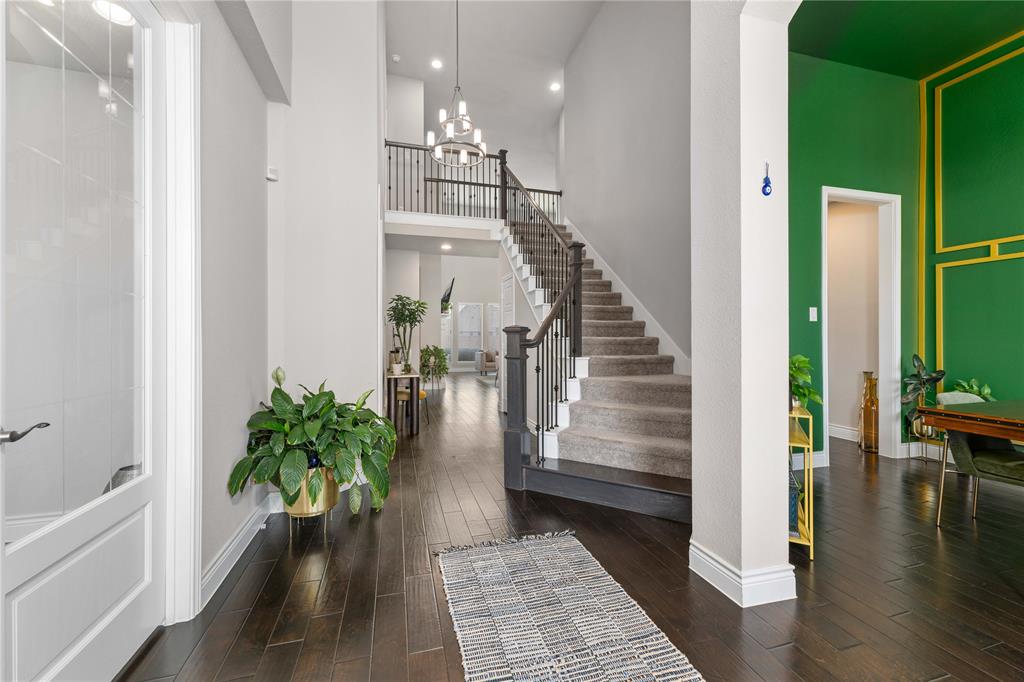 16541 Sweetgum Road Frisco, TX 75033 - Photo 5 of 28 Entryway featuring a high ceiling, dark wood-style floors, and hanging lights