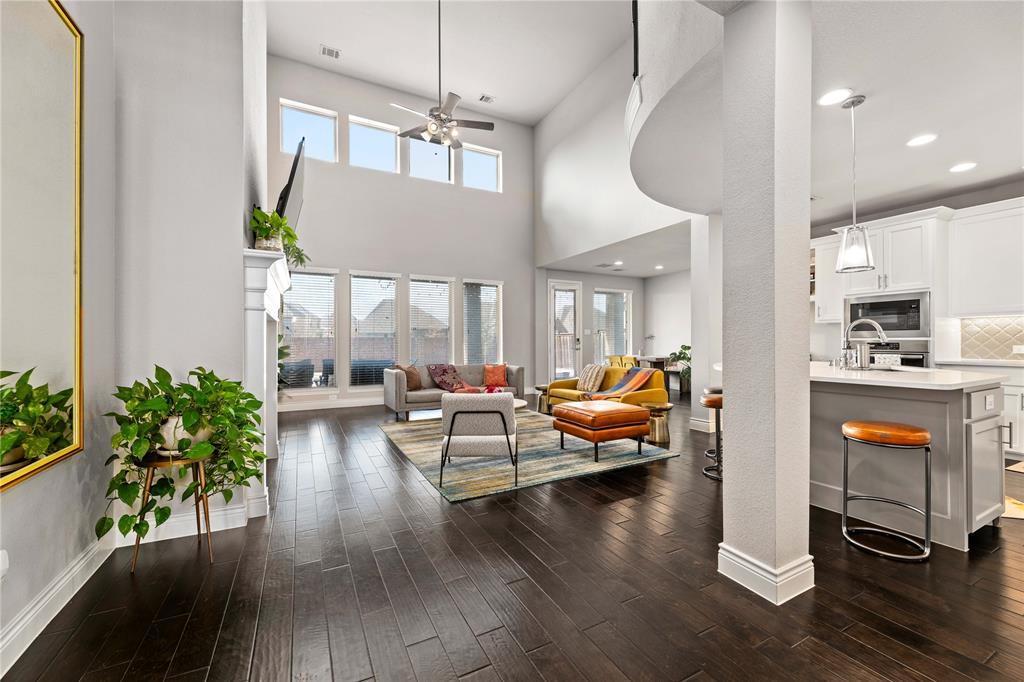 16541 Sweetgum Road Frisco, TX 75033 - Photo 6 of 28 Living room featuring dark wood finished floors, a high ceiling, ceiling fan, and recessed lighting