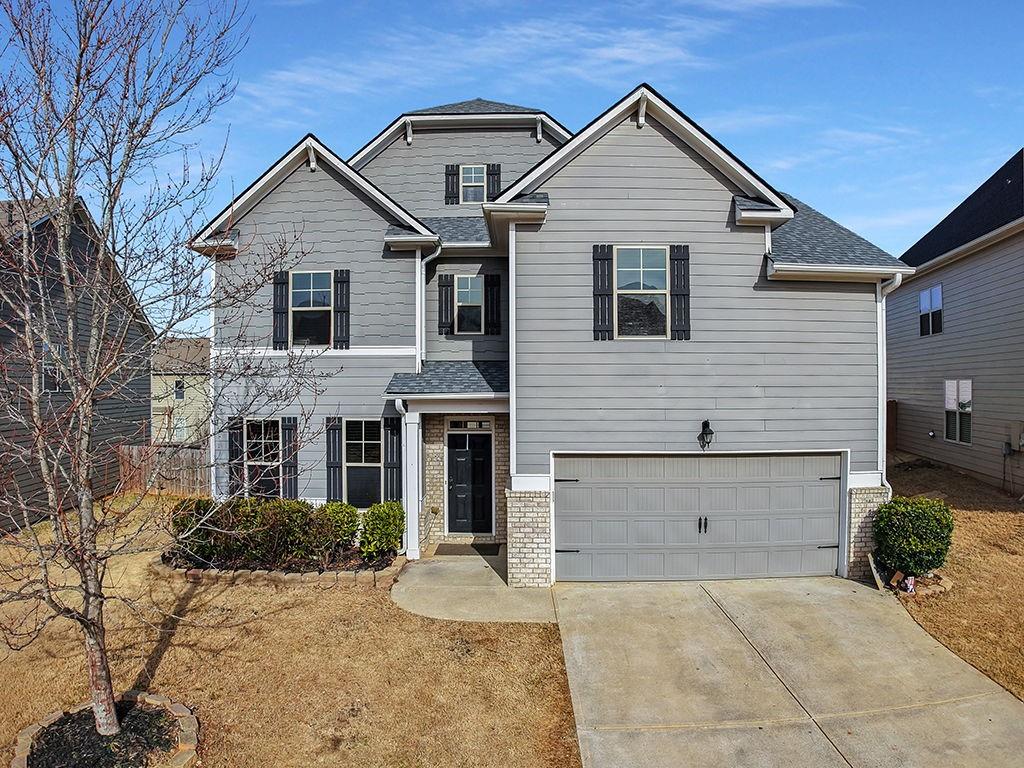 5110 Rialto Way Cumming, GA 30040 - Photo 1 of 50 a view of a house with a yard and large tree