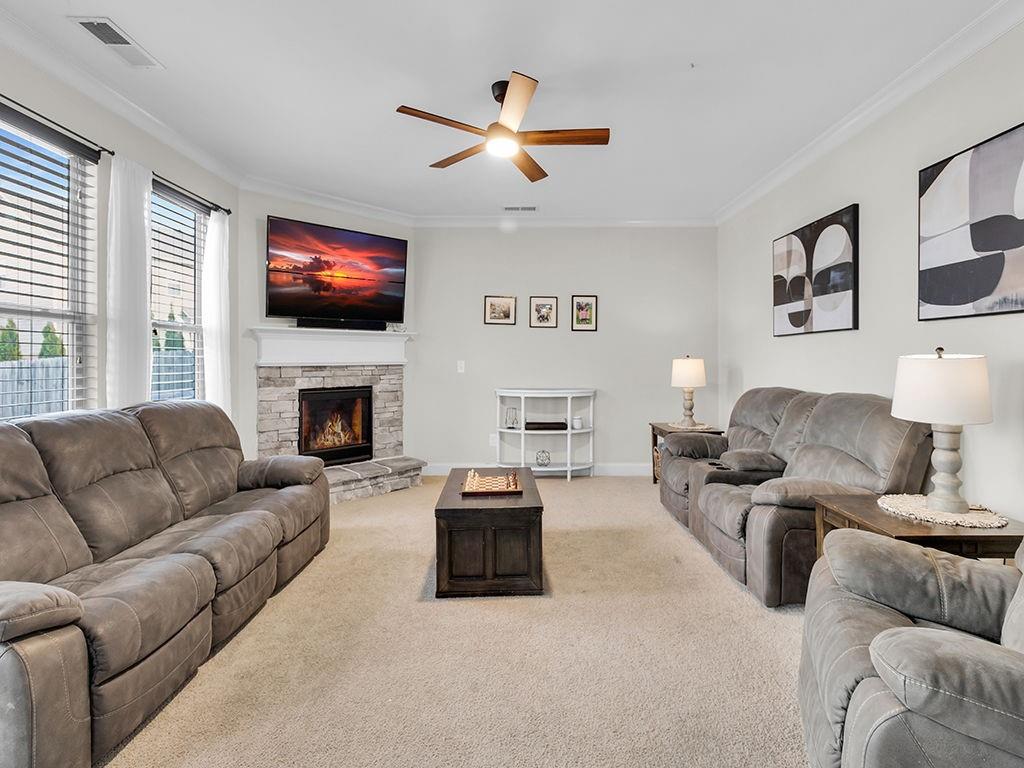 5110 Rialto Way Cumming, GA 30040 - Photo 16 of 50 a living room with furniture a flat screen tv and a fireplace