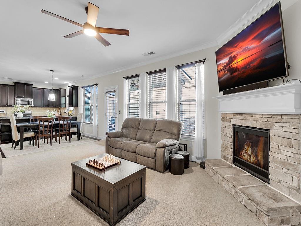 5110 Rialto Way Cumming, GA 30040 - Photo 17 of 50 a living room with furniture a flat screen tv and a fireplace
