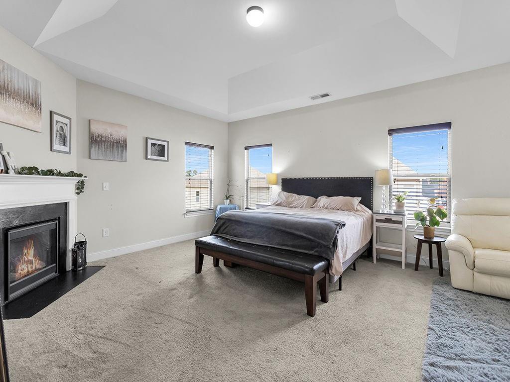 5110 Rialto Way Cumming, GA 30040 - Photo 19 of 50 a bedroom with a bed and a fireplace