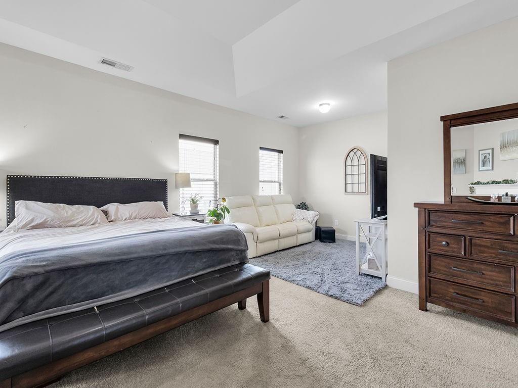 5110 Rialto Way Cumming, GA 30040 - Photo 20 of 50 a spacious bedroom with a bed and furniture