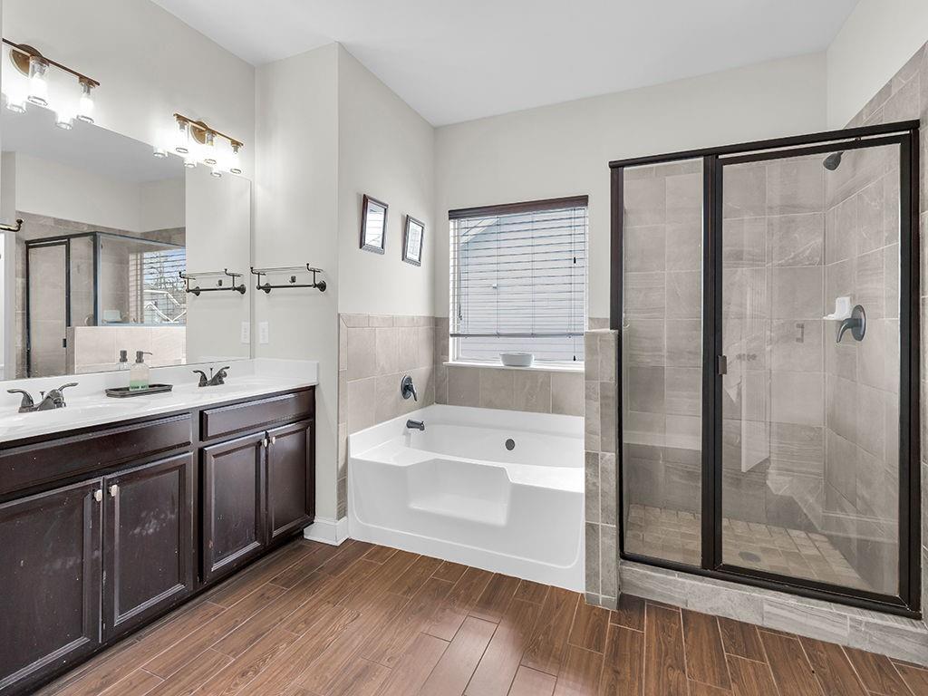 5110 Rialto Way Cumming, GA 30040 - Photo 22 of 50 a spacious bathroom with a tub sink shower and mirror