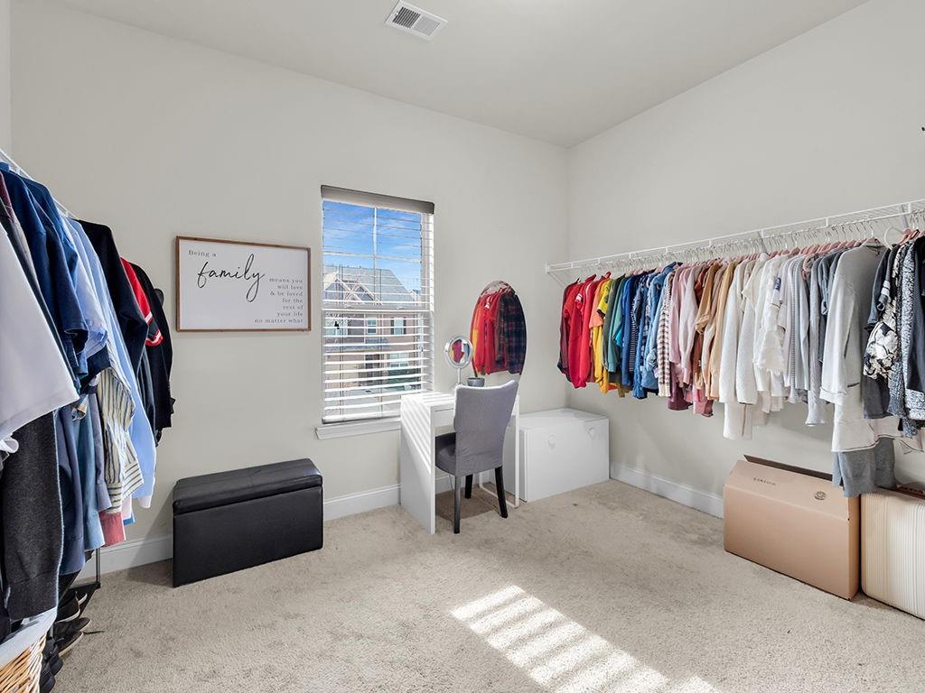 5110 Rialto Way Cumming, GA 30040 - Photo 23 of 50 a view of walk in closet with clothes and shoes