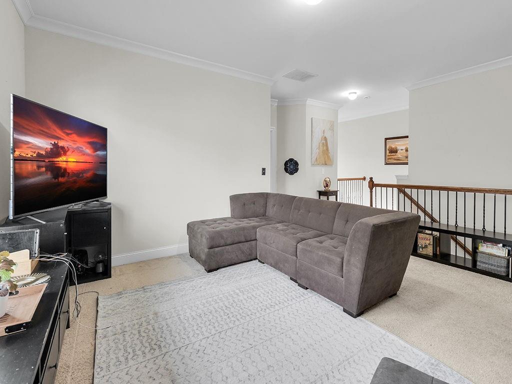 5110 Rialto Way Cumming, GA 30040 - Photo 25 of 50 a living room with furniture and a flat screen tv