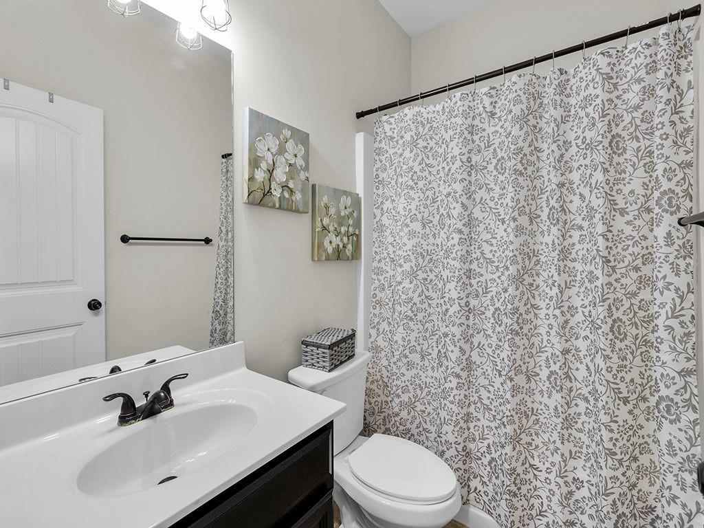 5110 Rialto Way Cumming, GA 30040 - Photo 32 of 50 a bathroom with a sink a toilet and a mirror