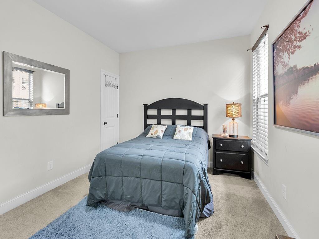 5110 Rialto Way Cumming, GA 30040 - Photo 34 of 50 a bedroom with a bed and a mirror