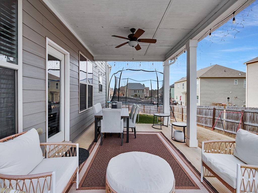 5110 Rialto Way Cumming, GA 30040 - Photo 36 of 50 a living room with furniture a large window and wooden floor