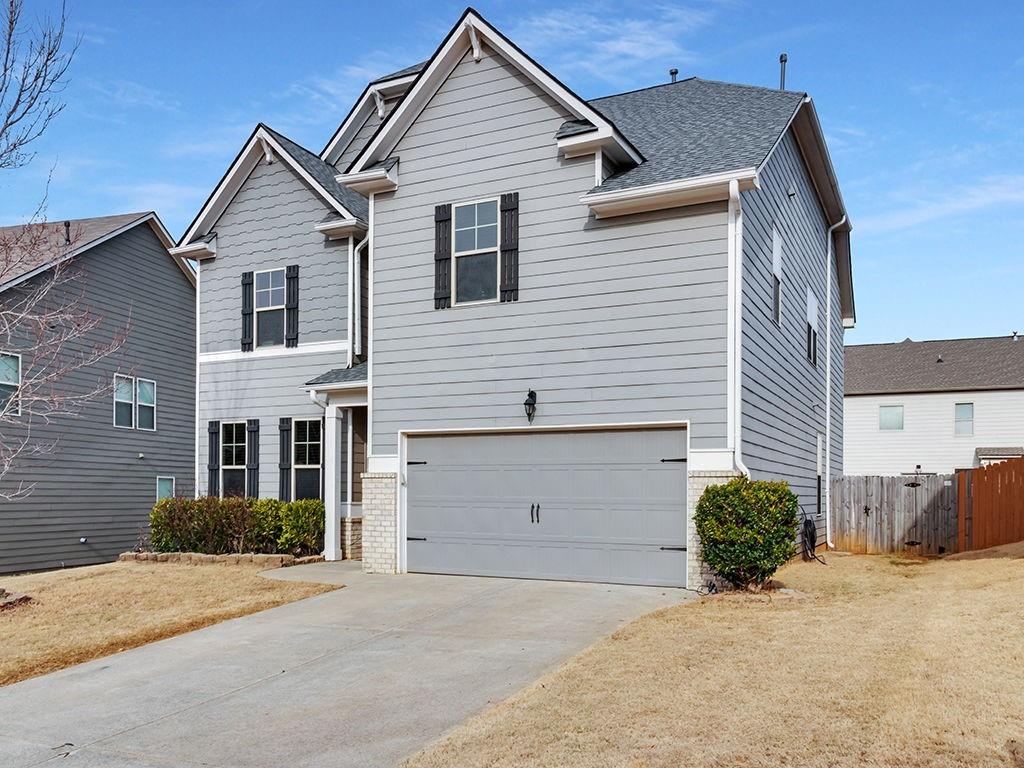 5110 Rialto Way Cumming, GA 30040 - Photo 6 of 50 a view of a house with a yard and garage