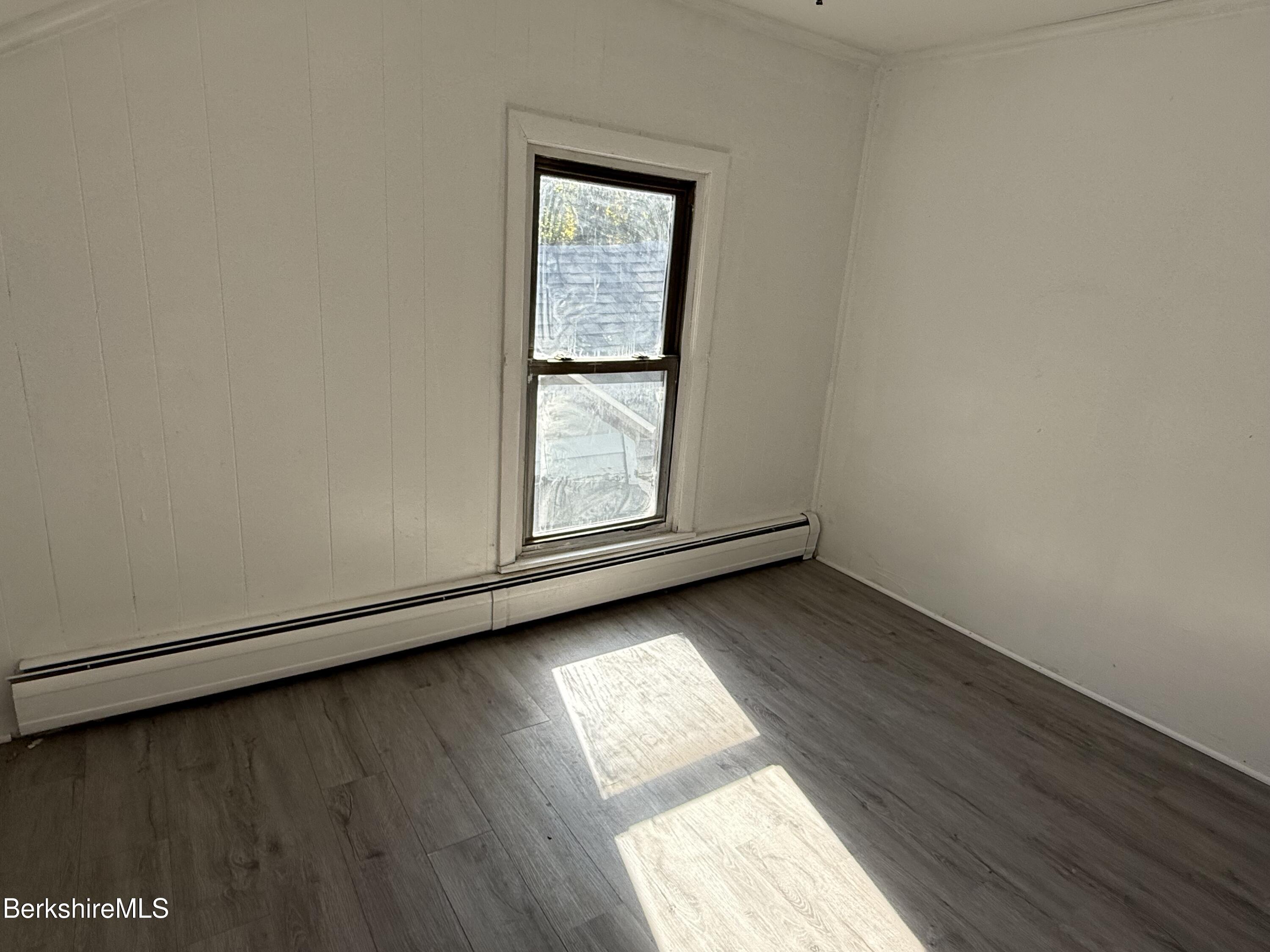 130 Commercial Street, Unit 1 Adams, MA 01220 - Photo 7 of 7 an empty room with wooden floor and windows