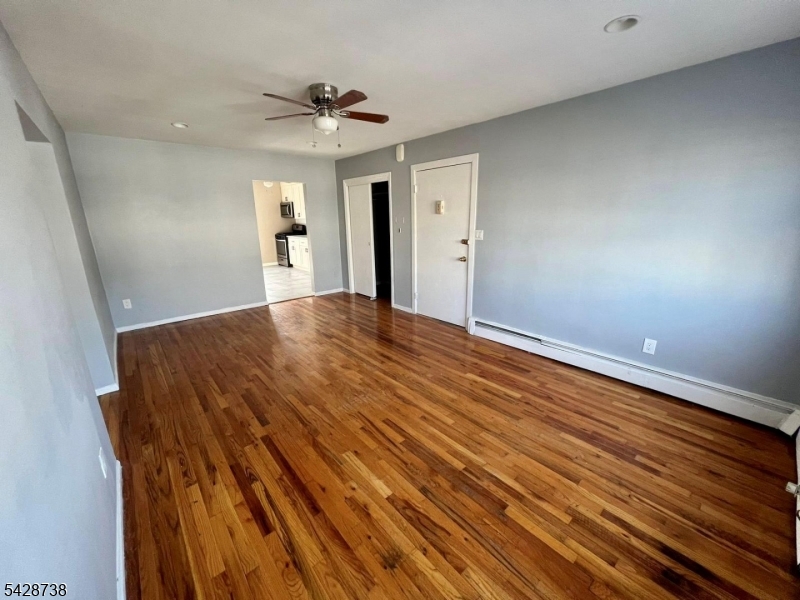26 Clinton Street, Unit 9 Belleville, NJ 07109 - Photo 2 of 6 a view of a livingroom with wooden floor and a ceiling fan