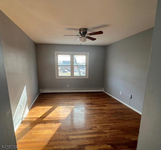 26 Clinton Street, Unit 9 Belleville, NJ 07109 - Photo 3 of 6 an empty room with wooden floor and windows