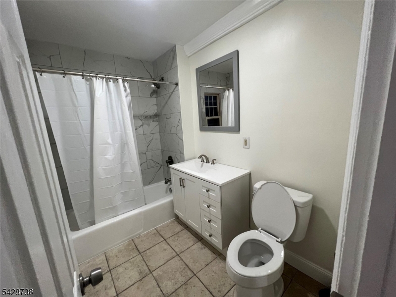 26 Clinton Street, Unit 9 Belleville, NJ 07109 - Photo 4 of 6 a bathroom with a granite countertop toilet sink and shower