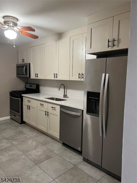26 Clinton Street, Unit 9 Belleville, NJ 07109 - Photo 6 of 6 a kitchen with stainless steel appliances granite countertop a sink a stove a refrigerator and cabinets