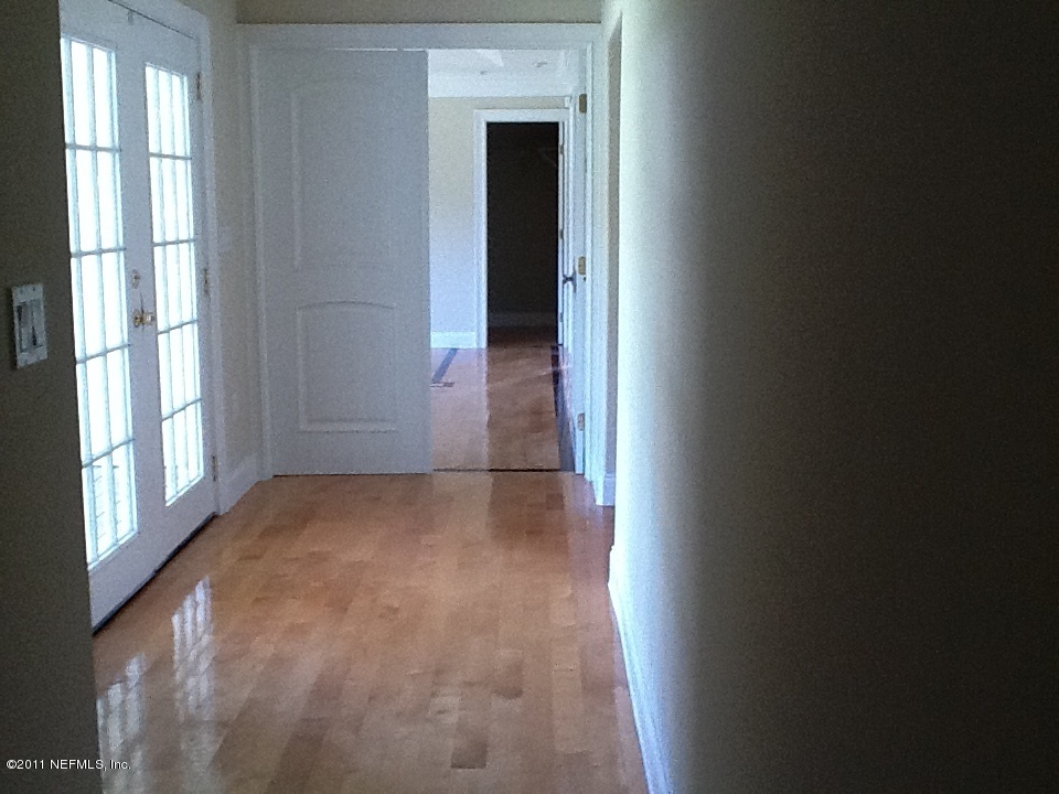 4130 Appaloosa Road Middleburg, FL 32068 - Photo 11 of 15 a view of a hallway with wooden floor and a window