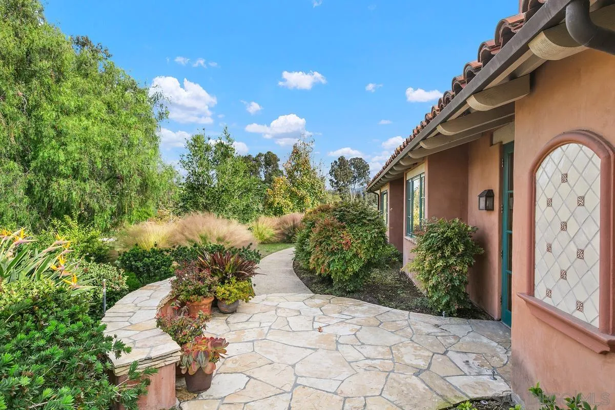 6150 Paseo Valencia Rancho Santa Fe, CA 92067 - Photo 33 of 53 a front view of a house with a yard
