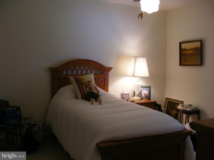174 River Road Pasadena, MD 21122 - Photo 14 of 28 a bedroom with a bed and a lamp on dresser
