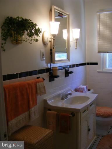 174 River Road Pasadena, MD 21122 - Photo 4 of 28 a bathroom with a sink and a mirror